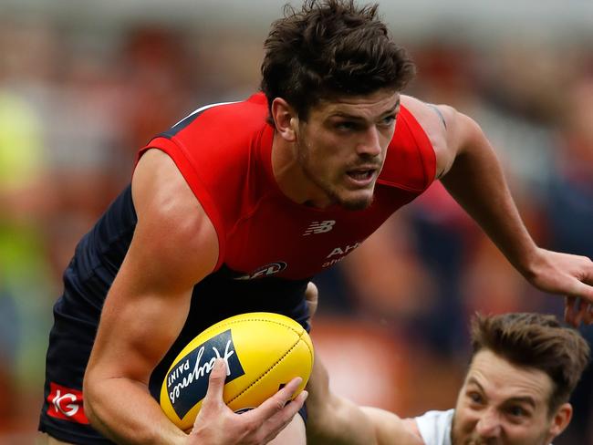 MELBOURNE, AUSTRALIA - APRIL 02: Angus Brayshaw of the Demons is tackled by Dale Thomas of the Blues during the 2017 AFL round 02 match between the Melbourne Demons and the Carlton Blues at the Melbourne Cricket Ground on April 02, 2017 in Melbourne, Australia. (Photo by Michael Willson/AFL Media/Getty Images)