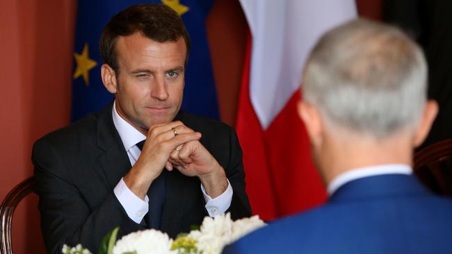 The French leader appears to throw a wink at Mr Turnbull. Picture: AFP