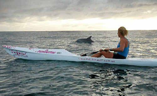 Kirsty Holmes paddling with a dolphin. Picture: Contributed