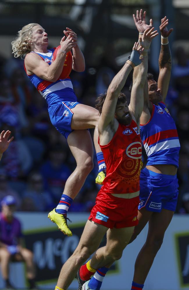 Cody Weightman takes a big firstt quarter mark over Sam Collins and Jamarra Ugle-Hagan. . Picture: Michael Klein