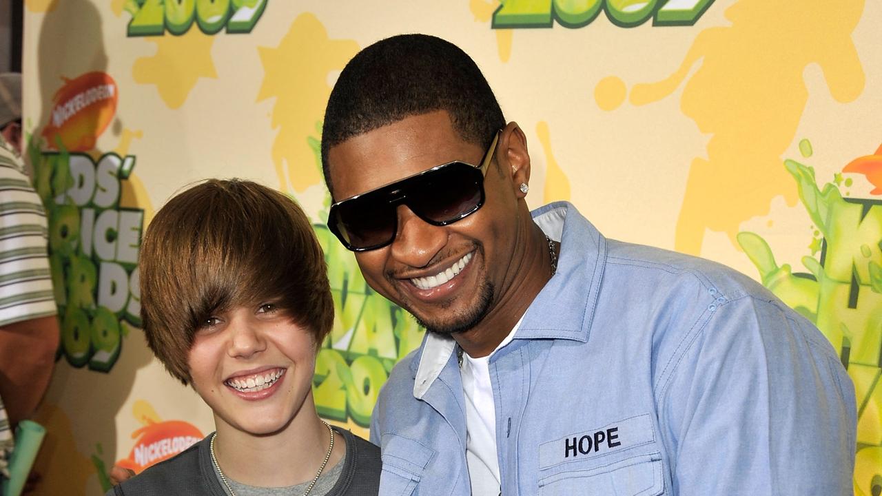 As a child star in 2009 with mentor Usher. Picture: Kevin Winter/Getty