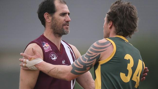 OSB Lonsdale's Trevor Rigney (left) is congratulated by Marion's Dean Saunders, for kicking 100 goals in season 2018. this season. Picture: Dean Martin