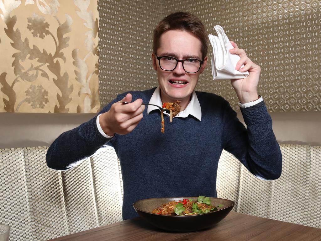 Courier Mail journalist Matthew Johnston eats Queensland's spiciest noodle dish at Fat Noodle restaurant at Treasury Casino. Picture: Zak Simmonds