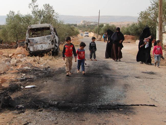 Syrians walk past the site near a US military raid in which IS leader Abu Bakr al-Baghdadi was killed. Picture: AFP