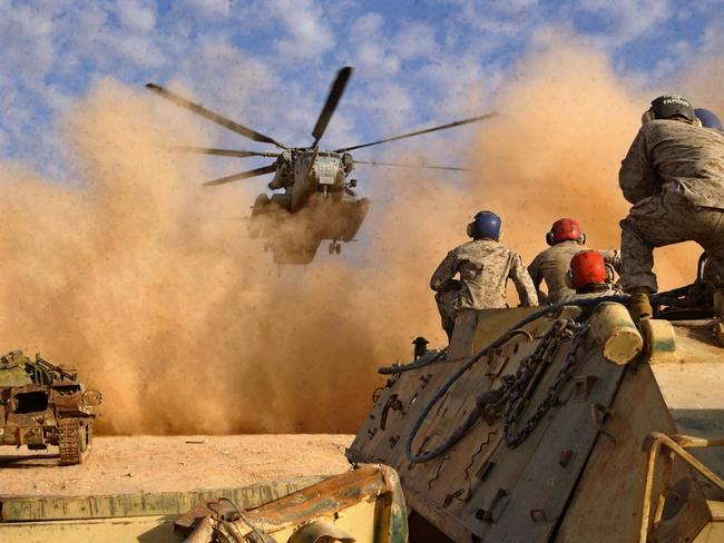 13/01/2005.  (FILE)--A picture released by the US Marines shows Support Team Marines watching for the approach of a CH-53E Super Stallion from Marine Medium Helicopter Squadron 166 (reinforced), Marine Aircraft Group 16,  while sitting on an old Iraqi armored personnel carrier. The White House 26 January 2005 said US officials were saddened by a CH-53 Super Stallion which crashed in Iraq that reportedly left more than 30 US soldiers dead in the biggest single loss of American life in Iraq since the 2003 invasion. AFP PHOTO/HO/USMC