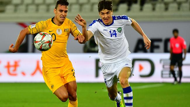 Australia's defender Trent Sainsbury vies for the ball with Uzbekistan's forward Eldor Shomurodov during the round of 16 n Al Ain on Tuesday morning. Picture: AFP
