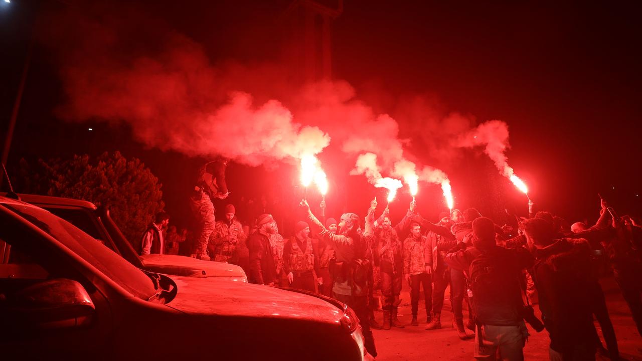 Syrian rebels and locals in the city Homs celebrating the success of the offensive two days ago. Picture: Abdulaziz Ketaz/AFP