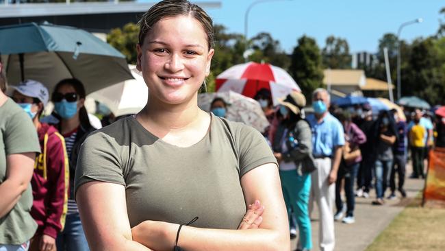 Tia-Moana Seumanutafa, 22, lines up out the front of the Logan Entertainment Centre to receive her COVID-19 vaccination. Picture: Zak Simmonds