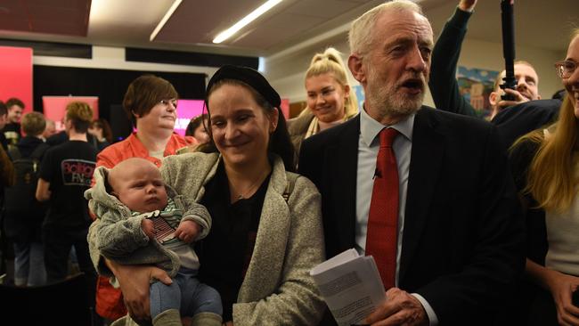 Opposition Labour party leader Jeremy Corbyn meets a supporter and baby after giving a speech on digitial infrastructure policy at an election campaign event in Lancaster.