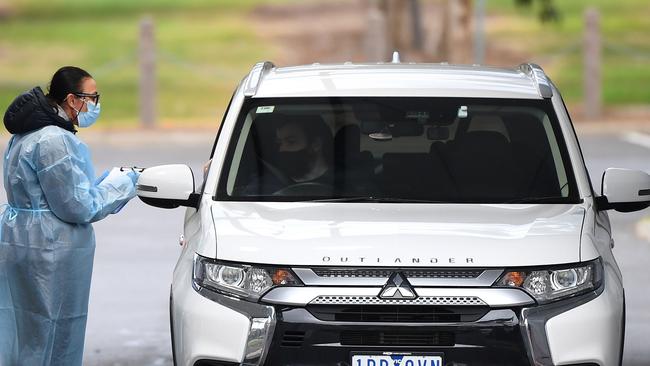 Medical staff prepare to take a swab at a drive-through testing clinic in Melbourne in August. Picture: William West/AFP