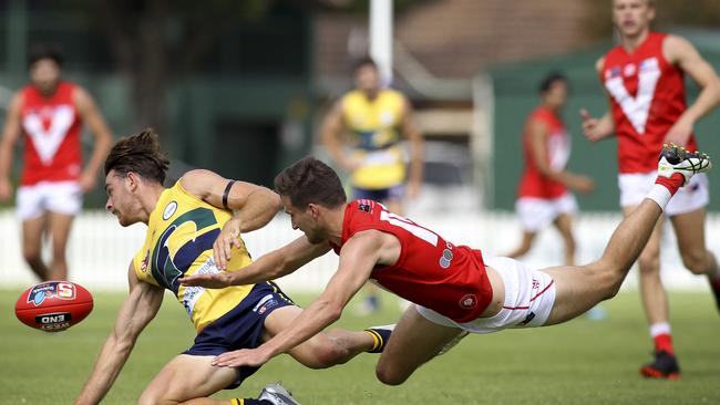 New Eagle Jordan Foote beats diving Rooster Tom Schwarz in the race for the ball at Woodville Oval. Picture: Dean Martin/AAP