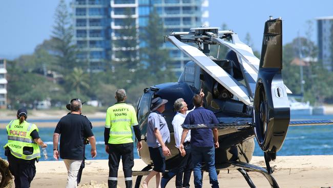 Aircrash investigators look over the crash site for more debris and inspect one of the Sea World Helicopters involved in the fatal collision. Picture NewsWire/David Clark