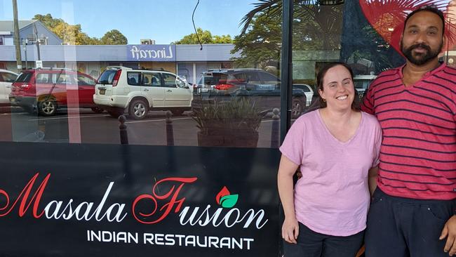 Satnam Singh Rath and his wife Erin Werner in front of their restaurant.