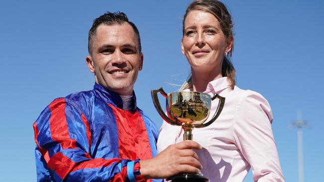 Winning jockey Michael Walker and handler Natasha Eaton pose with the cup after Prince Of Arran’s win in record time. Pic: AAP