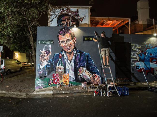 Artist Scott Marsh paints a mural of NSW Premier Mike Baird holding a kebab and glass of wine.