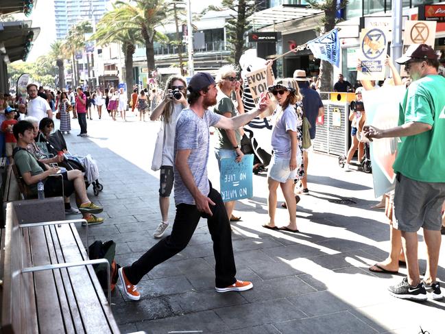A protester is confronted by a bystander. Picture: Nigel Hallett