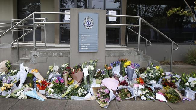 Floral tributes for the four killed officers are left outside Boroondara Police Station in Kew. Picture: David Caird