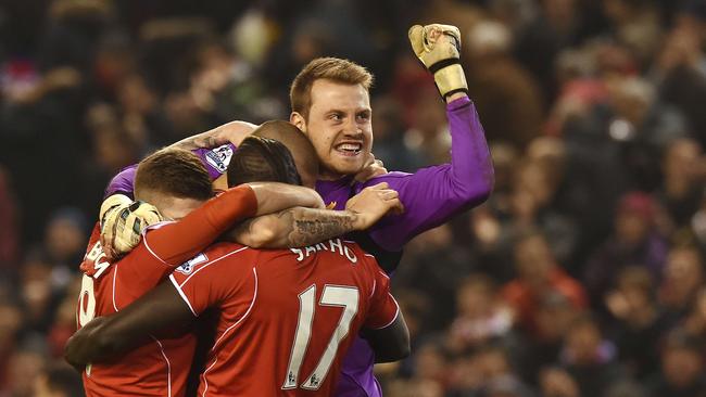 Liverpool's Belgian goalkeeper Simon Mignolet (R) celebrates their victory.