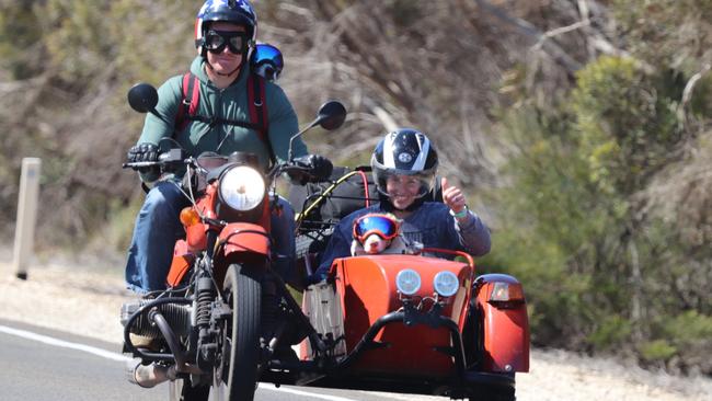 Nathan Coleman with dog Buddy strapped to his back, and in the sidecar, Ashleigh Coleman with dog Callie, riding in their Ural sidecar in country SA. Photo: Supplied