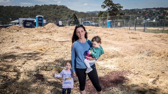 Jodie Williams — with daughters Mila, 3, and Emerson, 1 — fears arsenic poisoning at her land at Diamond Creek. Picture: Jake Nowakowski