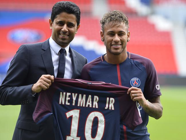 Neymar poses with his new jersey next to Paris Saint-Germain President Nasser Al-Khelaifi.