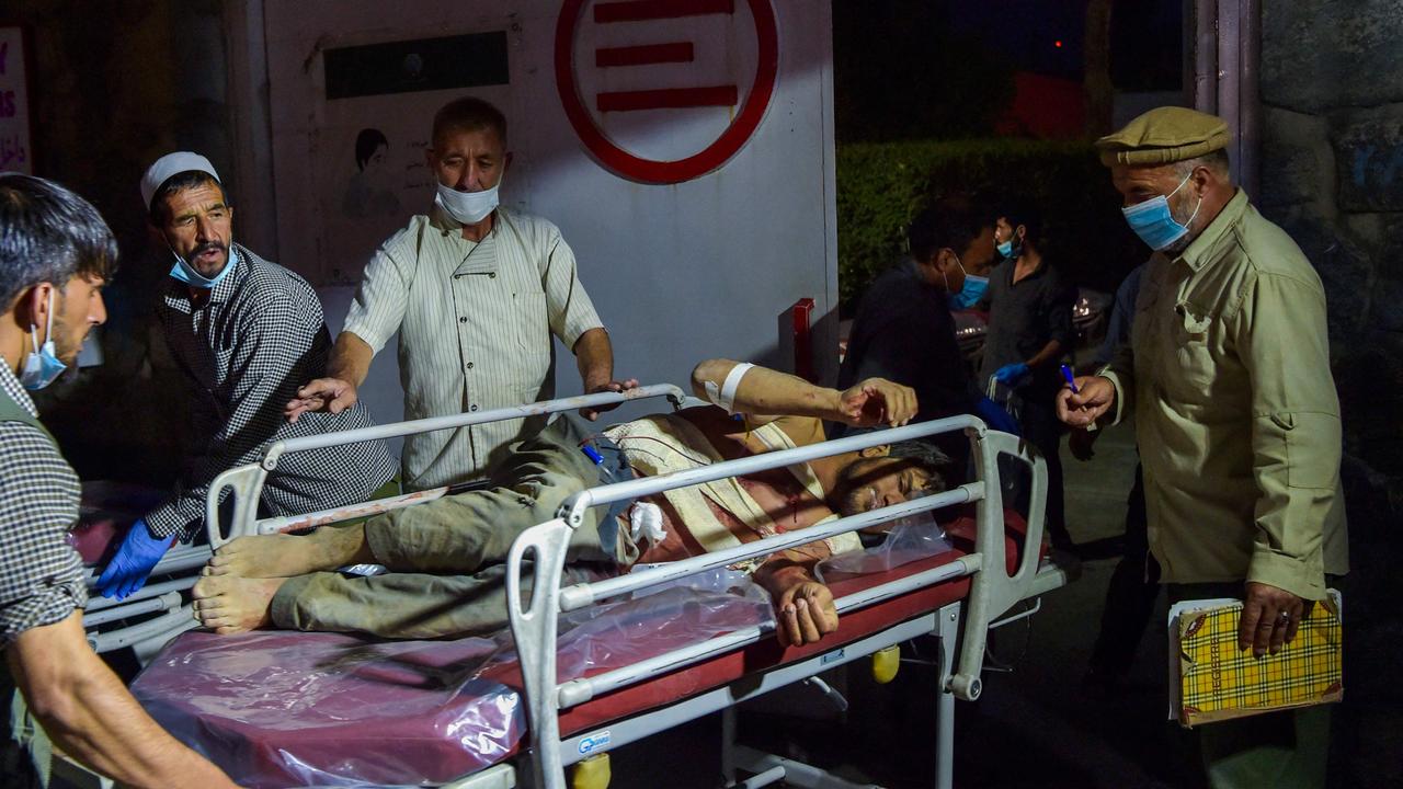 Medical and hospital staff bring an injured man on a stretcher for treatment after two powerful explosions. Picture: Wakil Kohsar/AFP