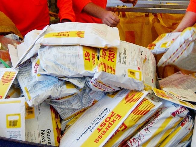 Mail Officers John Huston, Scott Connor and Team Leader Robyn Lowcock sort a large load of Christmas Express post mail as it arrives at the Townsville Mail Centre on its way all over Australia. Picture: Stewart Mclean  sm252030