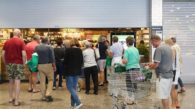 Early morning older shoppers arrive at Ascot Woolworths. Woolworths say they closed early on Wednesday night to restock shelves. Photographer: Liam Kidston