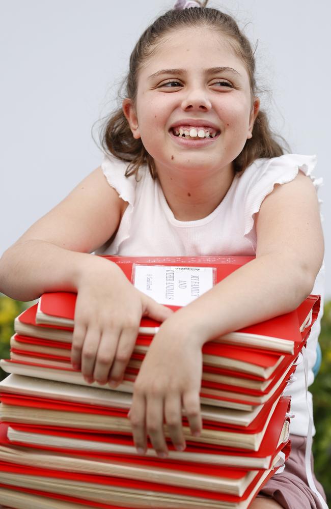 Bookworm Eva Garcia, 10, who contracted viral encephalitis just after her first birthday, volunteers at Braille House. Picture: Lachie Millard