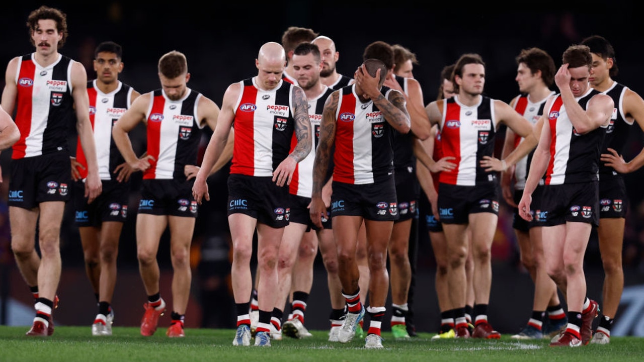 MELBOURNE, AUSTRALIA - AUGUST 12: Dejected St Kilda players walk from the ground after the round 22 AFL match between the St Kilda Saints and the Brisbane Lions at Marvel Stadium on August 12, 2022 in Melbourne, Australia. (Photo by Darrian Traynor/Getty Images)