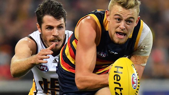 Hugh Greenwood fires out a handball against Hawthorn at Adelaide Oval. Picture: Daniel Kalisz (Getty Images)