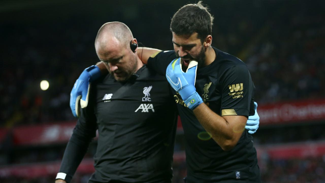 Liverpool's goalkeeper Alisson Becker, right, was injured against Norwich. (AP Photo/Dave Thompson)