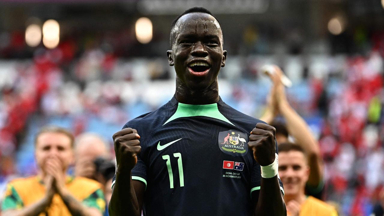 Australia's forward #11 Awer Mabil celebrates after winning the Qatar 2022 World Cup Group D football match between Tunisia and Australia at the Al-Janoub Stadium in Al-Wakrah, south of Doha on November 26, 2022. (Photo by Anne-Christine POUJOULAT / AFP)