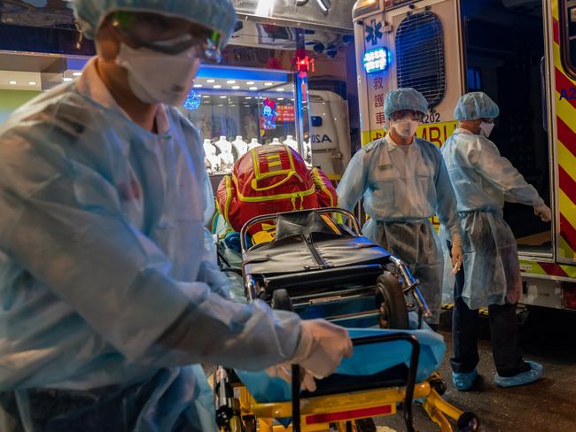 ***BESTPIX*** HONG KONG, CHINA - February 23: Paramedics wearing personal protective equipment carry a stretcher off an ambulance at North Point district on February 23, 2020 in Hong Kong, China. South Korea has raised the Wuhan Covid-19 virus alert to the "highest level" as confirmed case numbers keep rising. Four more people in Hong Kong were confirmed to have contracted with coronavirus, including two elderly women who recently visited a North Point Buddhist worship hall, bringing the total tally of cases in the city to 74.(Photo by Anthony Kwan/Getty Images)