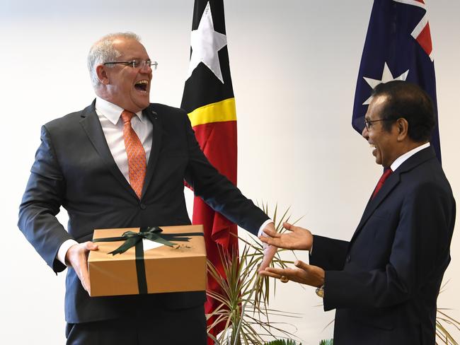 Australian Prime Minister Scott Morrison and East Timor Prime Minister Taur Matan Ruak exchange presents at the end of a bilateral meeting in Dili, East Timor on Friday. Picture: AAP Image/Lukas Coch