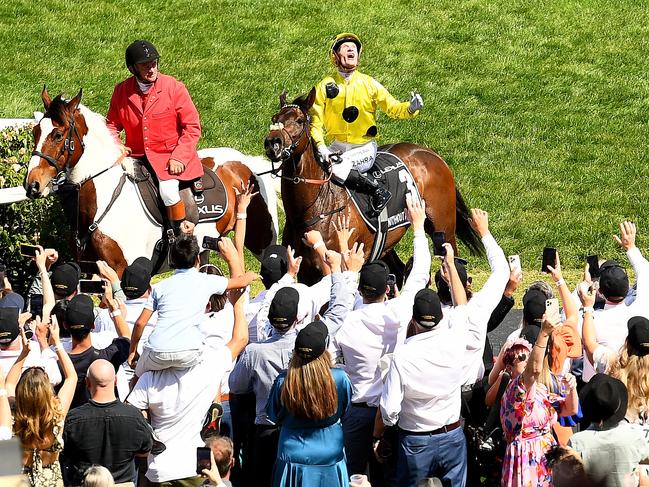 MELBOURNE, AUSTRALIA - NOVEMBER 07: Mark Zahra riding Without A Fight celebrates winning Race 7, the Lexus Melbourne Cup during Melbourne Cup Day at Flemington Racecourse on November 07, 2023 in Melbourne, Australia. (Photo by Josh Chadwick/Getty Images)