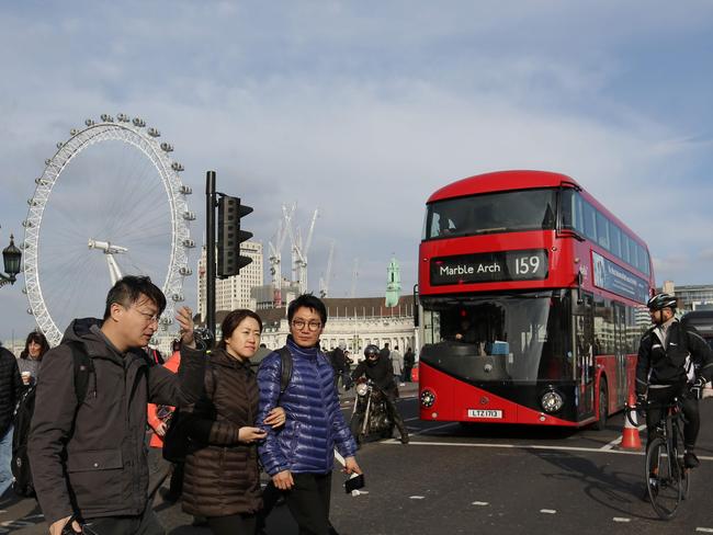 Members of the public and traffic cross Westminster Bridge in central London on March 23, 2017 after it reopened following the March 22 terror attack at the British parliament. Picture: AFP