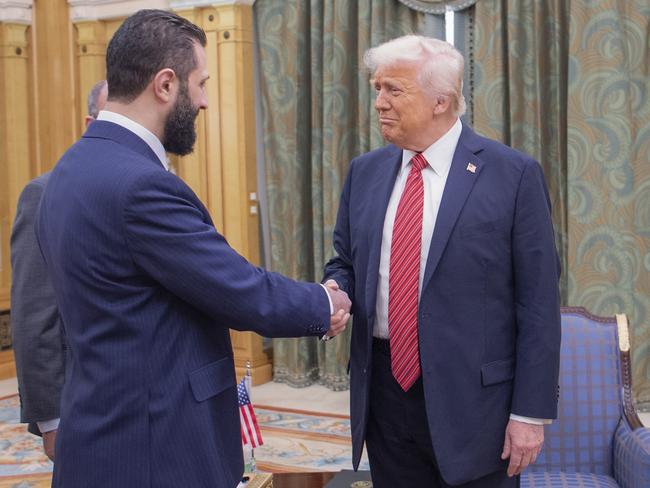 In this photo released by the Saudi Royal Palace, President Donald Trump, right, shakes hands with Syria's interim President Ahmad al-Sharaa, in Riyadh, Saudi Arabia, Wednesday, May 14, 2025. (Bandar Aljaloud/Saudi Royal Palace via AP)
