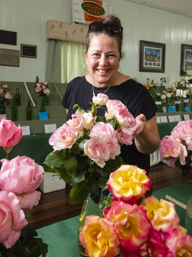 Nardia Booshand of the Friends of the Queensland State Rose Garden admires the entries in the 2022 Spring Champion Rose Show at the Rose Cottage in the Queensland State Rose Garden, Saturday, October 8, 2022. Picture: Kevin Farmer