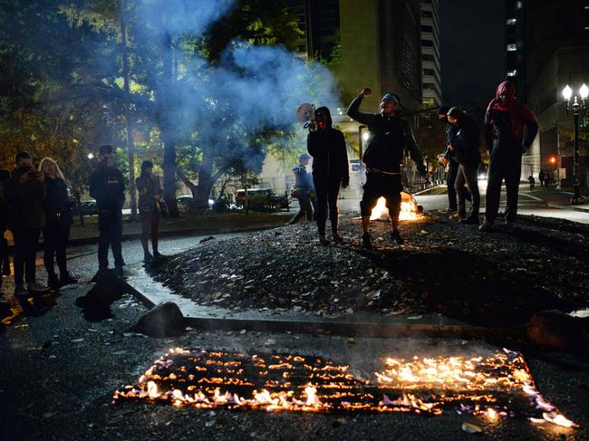 Protesters burn the American flag outside the Mark O. Hatfield United States Courthouse in Portland, Oregon the day after the election. Picture: AFP