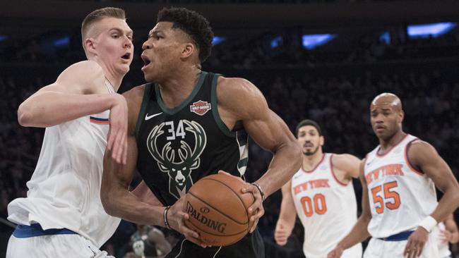 Kristaps Porzingis takes on Giannis Antetokounmpo (R).