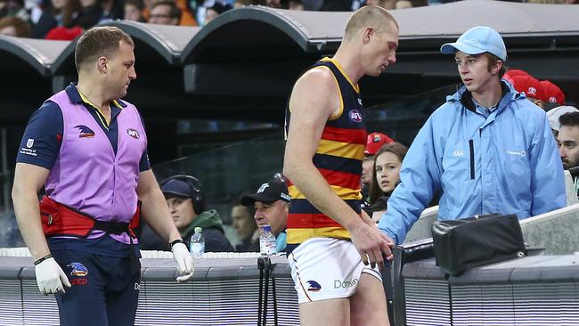 Crows ruckman Sam Jacobs goes down the race to the rooms for treatment on a back complaint. Picture: Sarah Reed