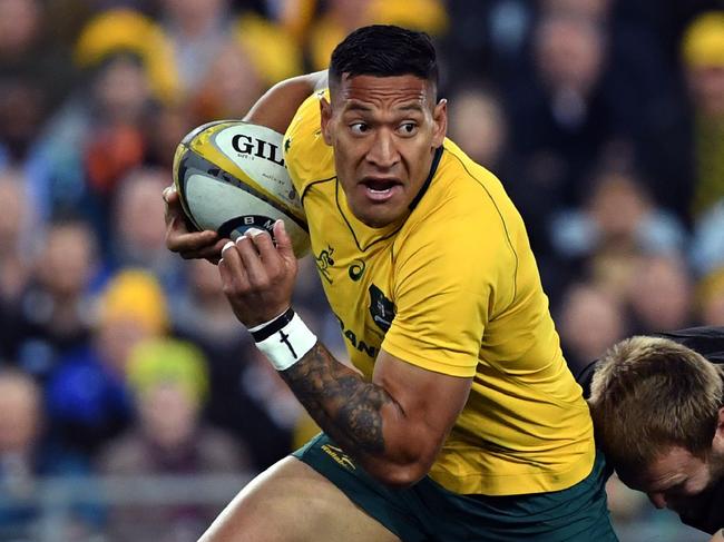 (FILES) In this file photo taken on August 19, 2017, Australia's fullback Israel Folau (C) is tackled by New Zealand's hooker Codie Taylor during their Rugby Championship test match in Sydney. - Rugby Australia said April 11, 2019 that it intends to terminate superstar Israel Folau's contract over his latest anti-gay rant, throwing the Wallabies' World Cup plans into disarray. (Photo by WILLIAM WEST / AFP) / IMAGE RESTRICTED TO EDITORIAL USE - STRICTLY NO COMMERCIAL USE