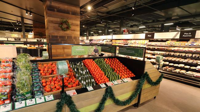 Christmas decorations already deck the halls, with the store’s fruit and vegetable section taking shape. Picture: AAP Image/Richard Gosling