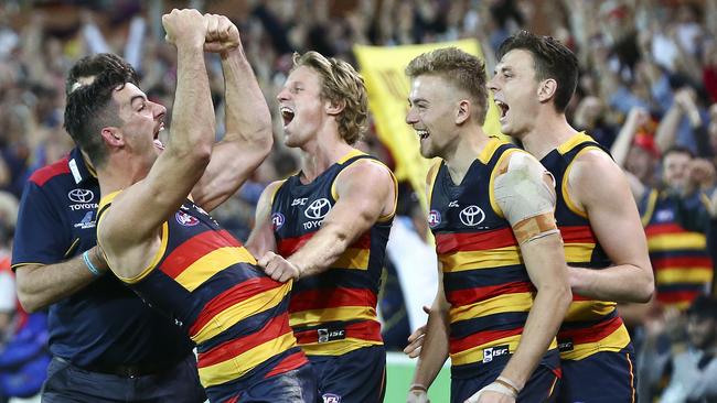 Taylor Walker, Rory Sloane, Hugh Greenwood and Jake Lever celebrate the preliminary final win. Picture: Sarah Reed