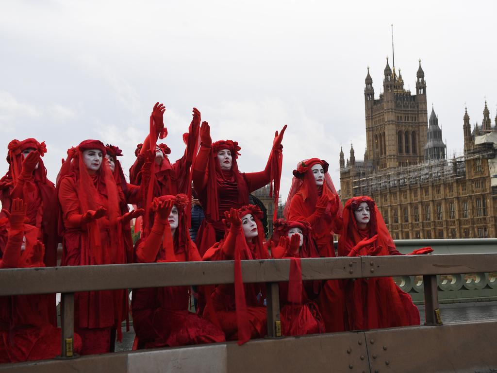 Members of The Red Brigade of The Invisible Circus walk across Westminster Bridge in London. Picture: Chris J Ratcliffe/Getty Images