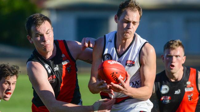 Rostrevor's James Butterworth battles for the ball with Blake Penney from Tea Tree Gully. Picture: AAP Image/ Brenton Edwards