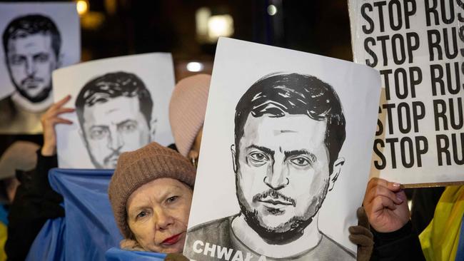 A woman holds a portrait of Ukraine's President Volodymyr Zelensky as Poles and members of the Ukrainian diaspora take part in a rally in front of the US embassy in Warsaw on March 3, 2025, to protest after US President Doland Trump clashed with Zelensky during an official meeting in Oval Office in the White House. Picture: AFP