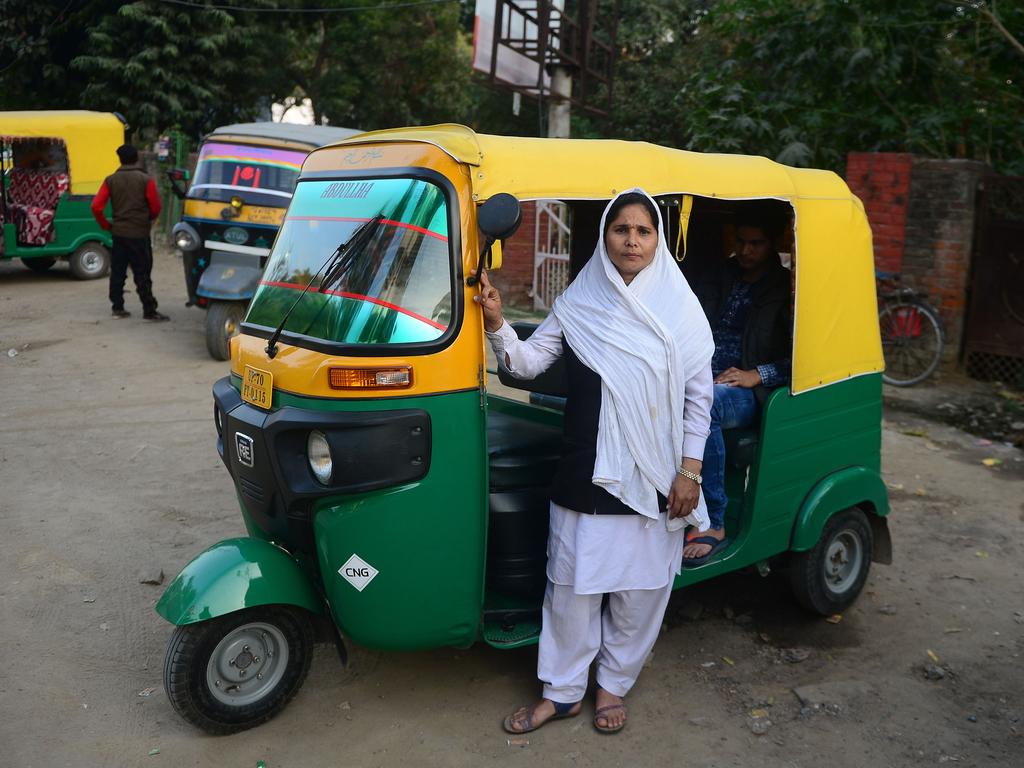 Tabasumm, 30, an auto-rickshaw driver, with her vehicle in Allahabad, India. Picture: AFP
