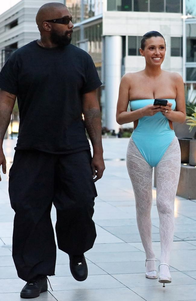 While the one piece looks like it’s threatening an imminent wardrobe malfunction, the white tights - which Censori has worn on loop all week - were relatively modest. Meanwhile, Kanye wore black head-to-toe. Picture: BACKGRID Australia